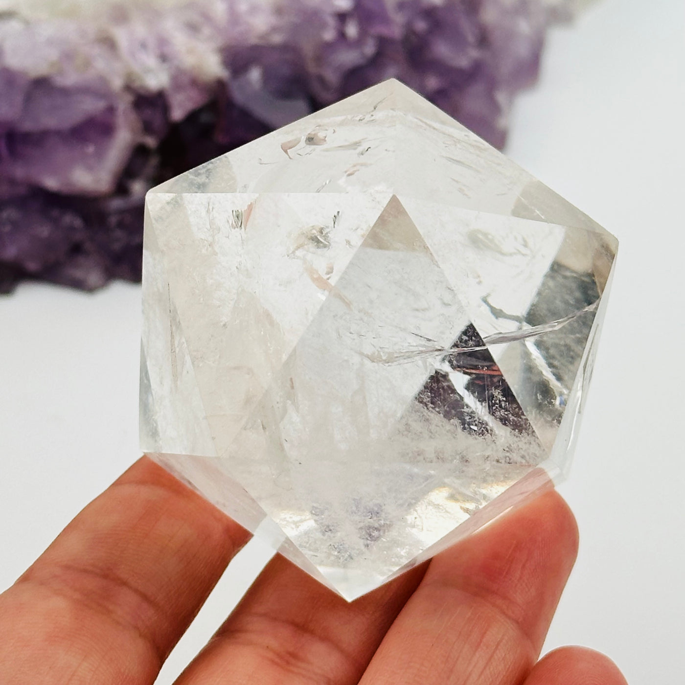 crystal quartz icosahedron in hand for size reference 