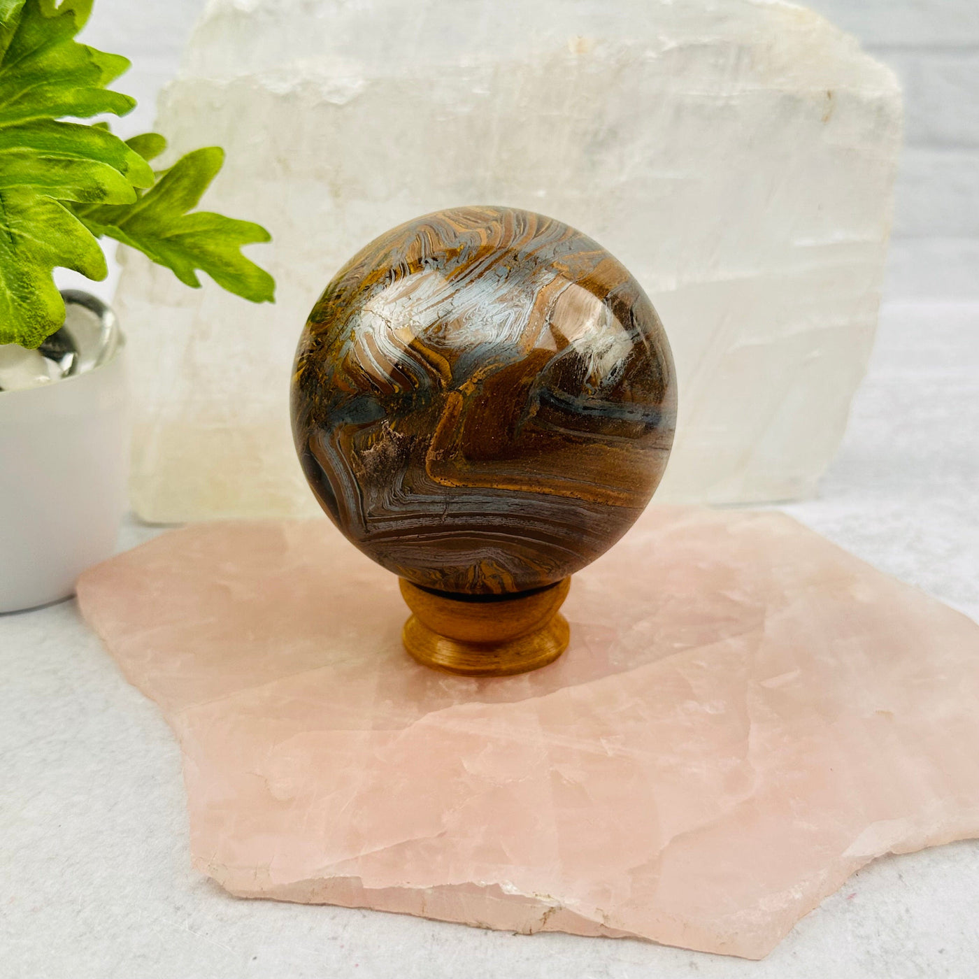 Tigers Eye with Hematite Polished Sphere displayed as home decor 