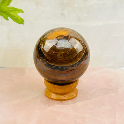 Tigers Eye with Hematite Polished Sphere displayed as home decor