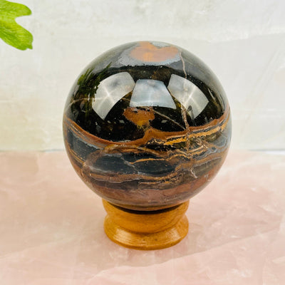 Tigers Eye with Hematite Polished Sphere displayed as home decor