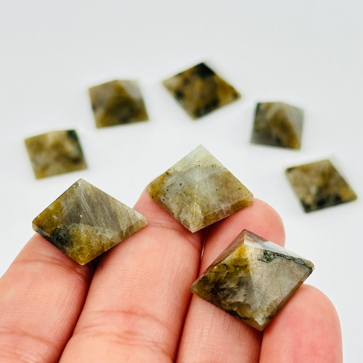 labradorite pyramids in hand for size reference 