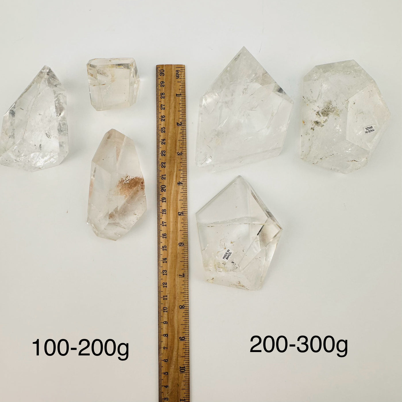 free formed crystals displayed next to a ruler for size reference 