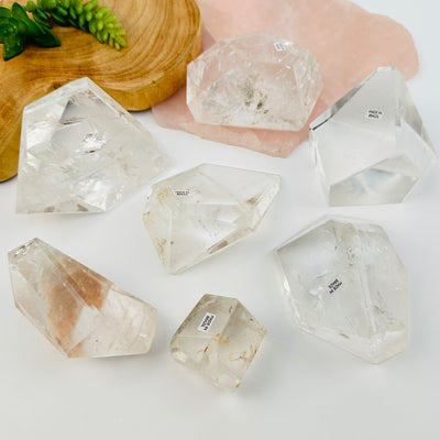 multiple crystal quartz polished free formed crystals displayed to show the differences in the sizes and shapes  