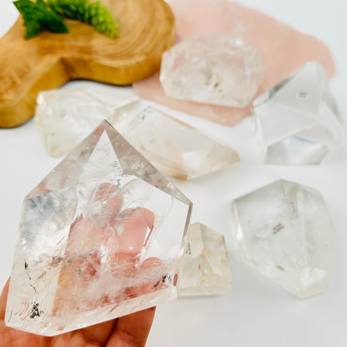 crystal quartz polished freeform in hand for size reference 