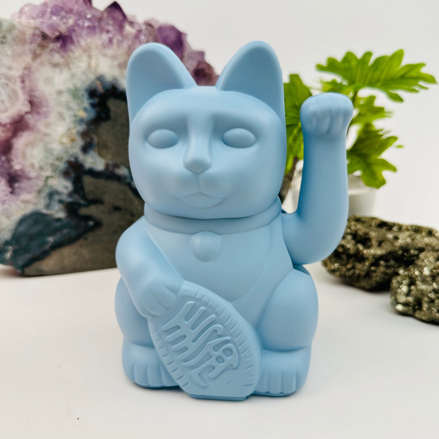 soft blue colored lucky cat displayed as home decor 