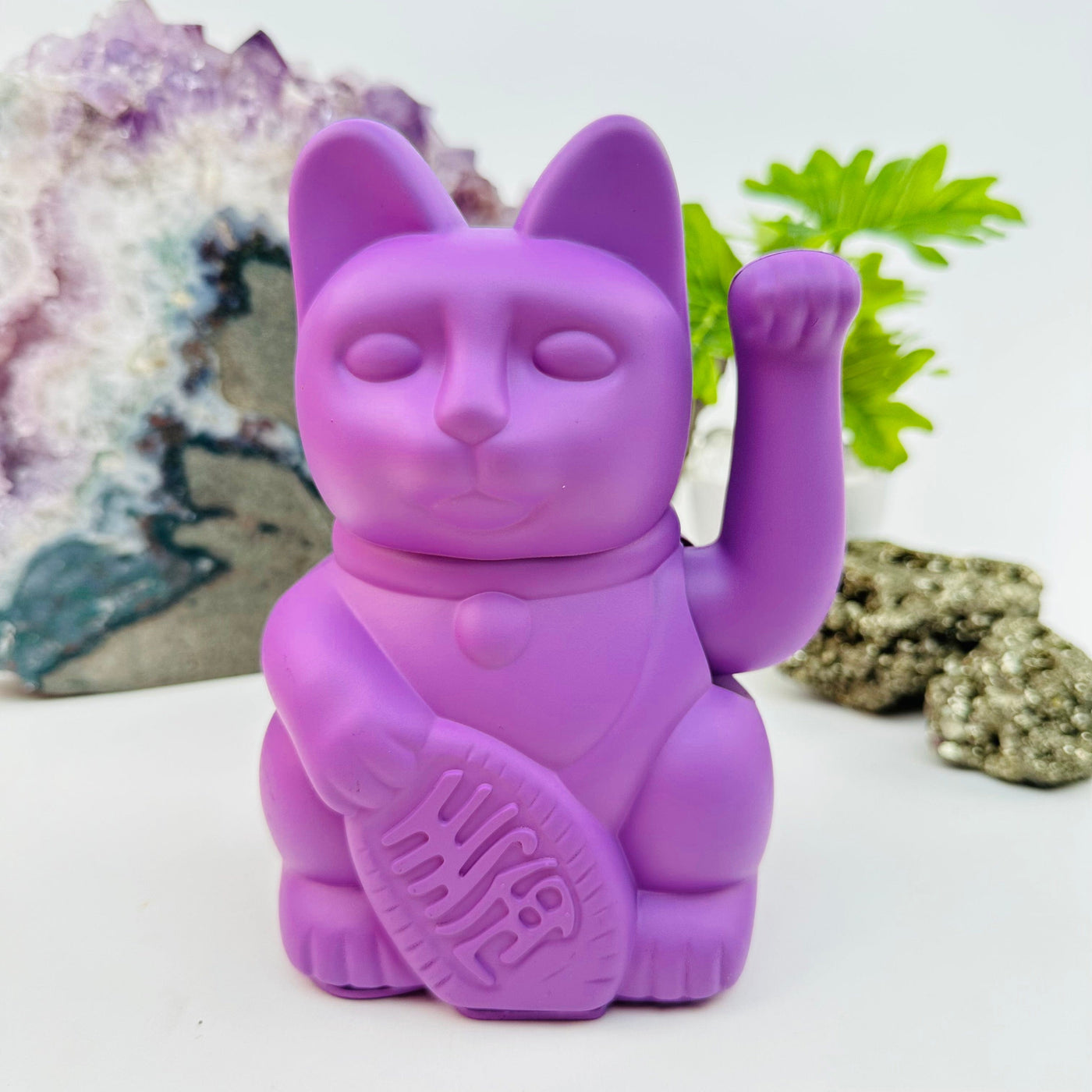 mauve colored lucky cat displayed as home decor 