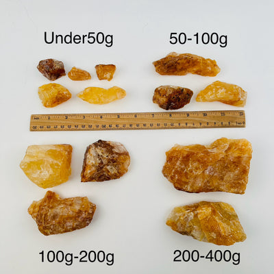 golden healer crystals sold by weight. displayed next to a ruler for size reference 