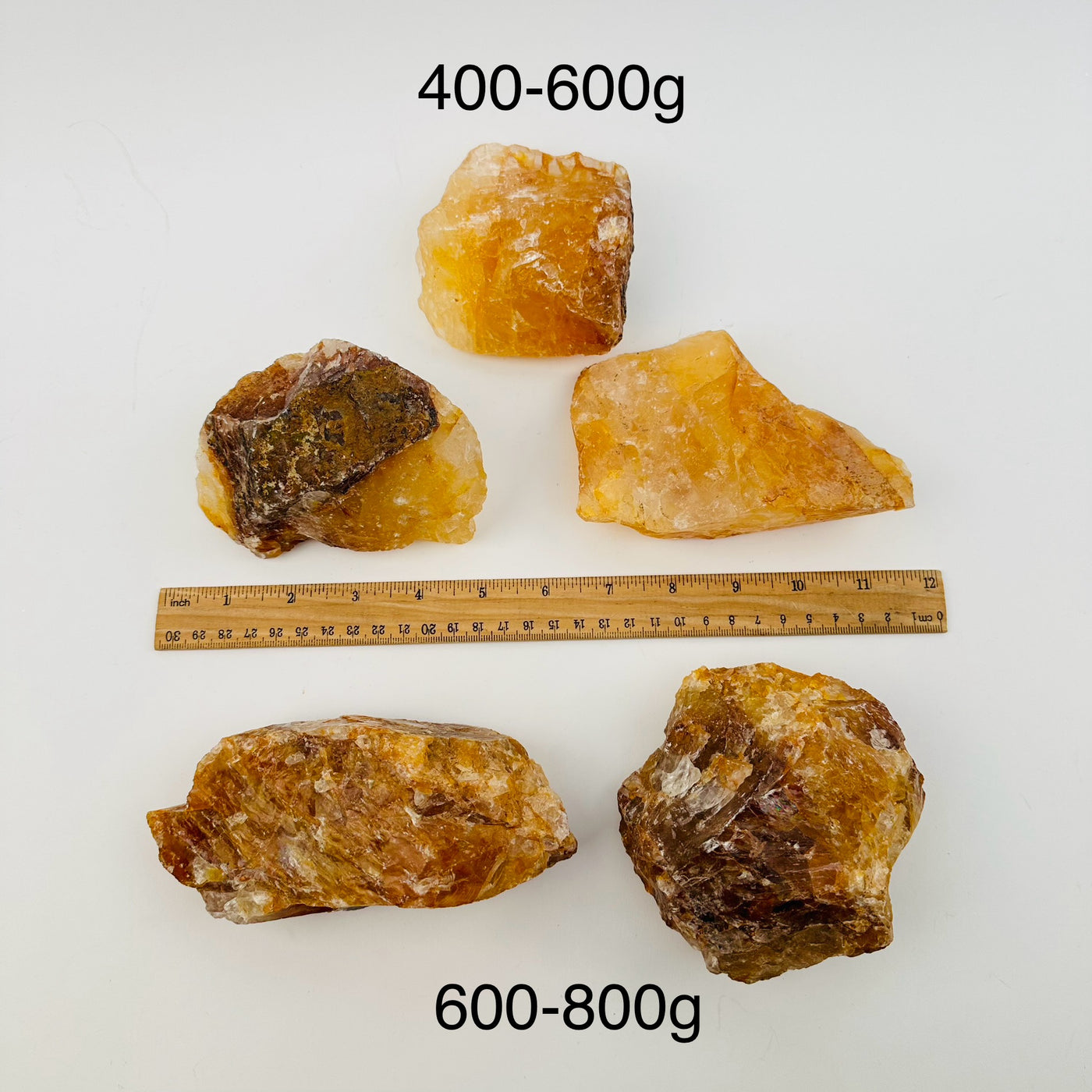 golden healer crystals sold by weight. displayed next to a ruler for size reference 