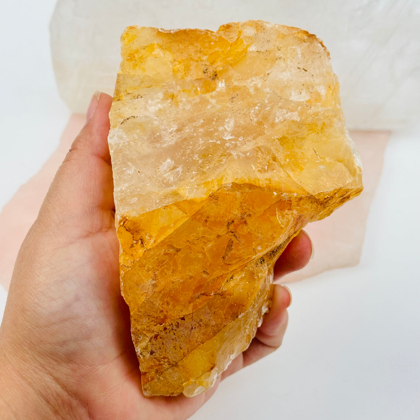 golden amethyst crystal cluster in hand for size reference 