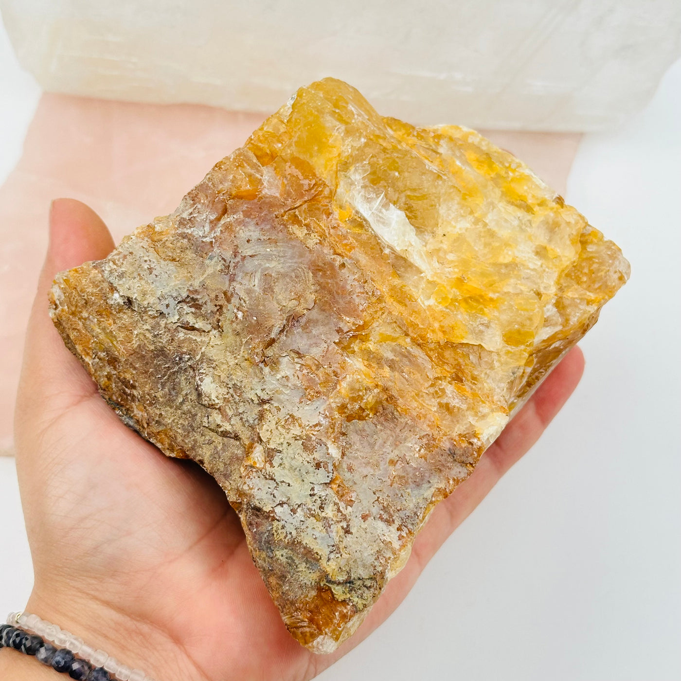 golden healer crystal in hand for size reference 