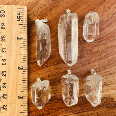 Crystal Quartz Polished Point Pendant Charm - Silver Bail next to a ruler for size reference 