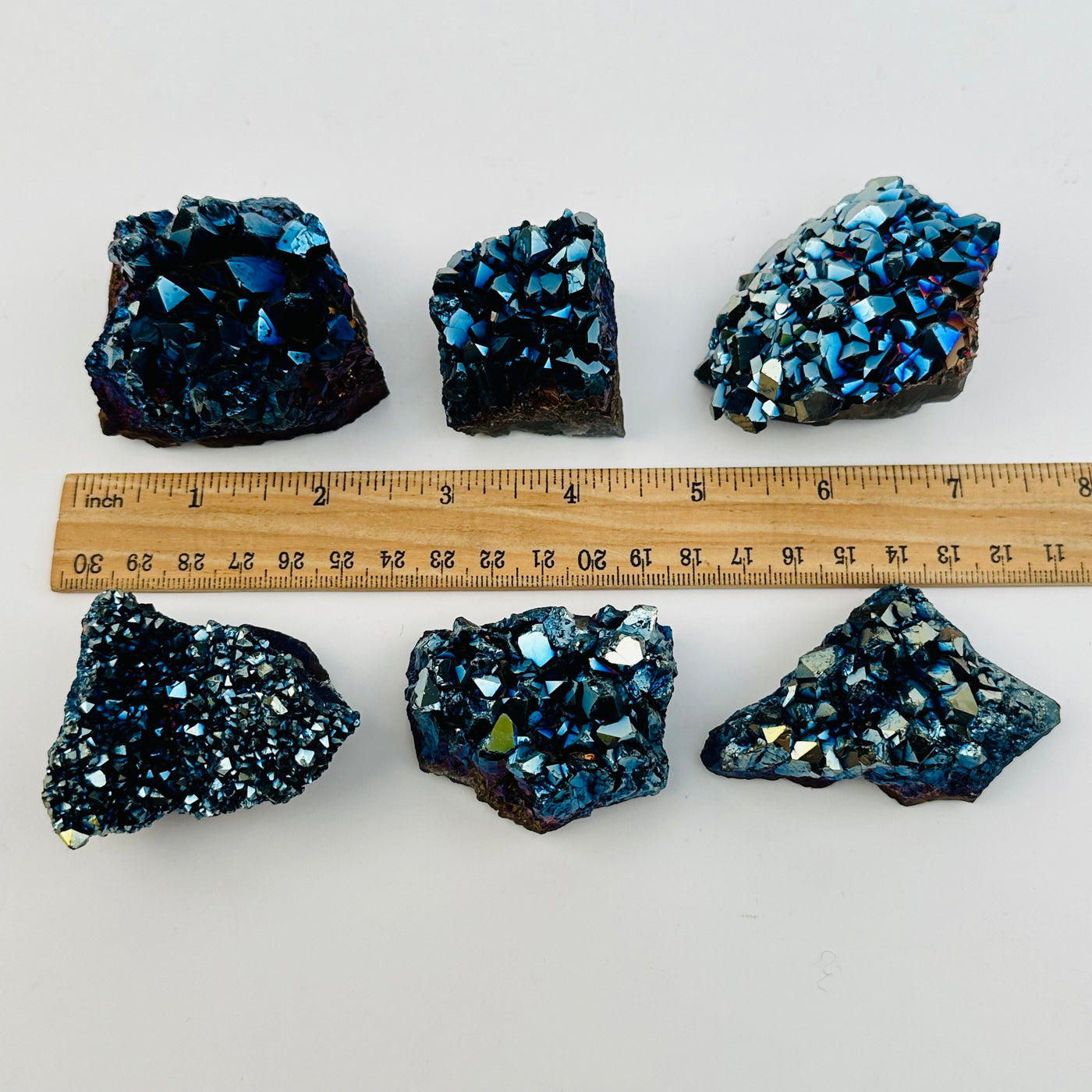 crystal clusters next to a ruler for size reference 