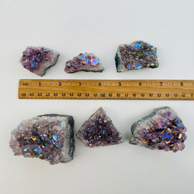 crystal clusters next to a ruler for size reference 