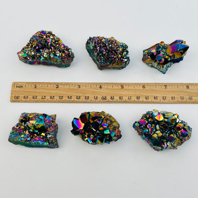 crystal clusters next to a ruler for size reference