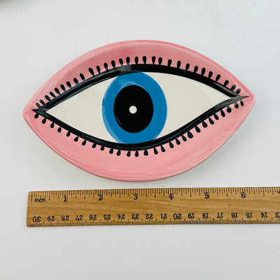 all seeing eye ceramic bowl next to a ruler for size reference 