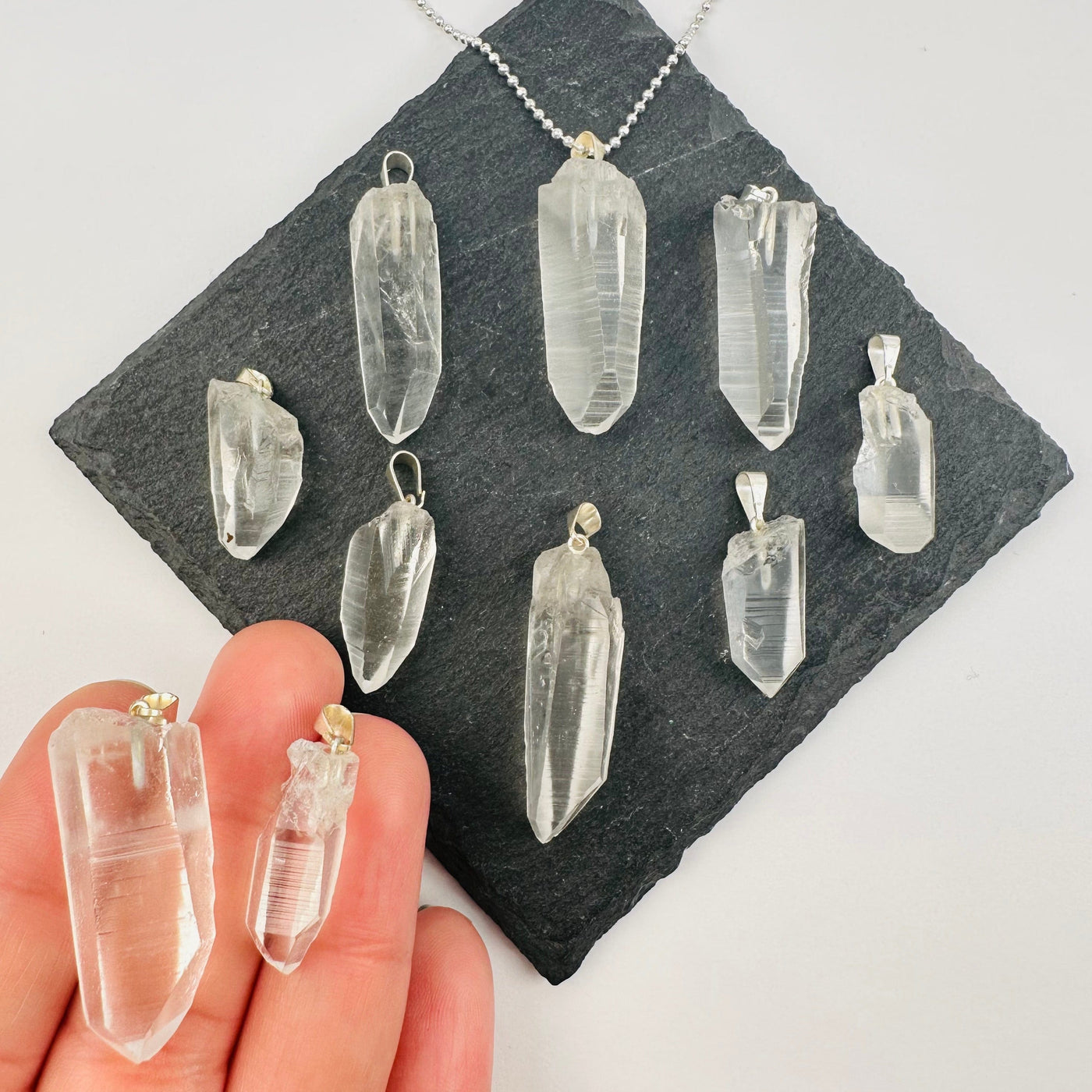 Lemurian Point Crystal Pendant with silver bail in hand for size reference 