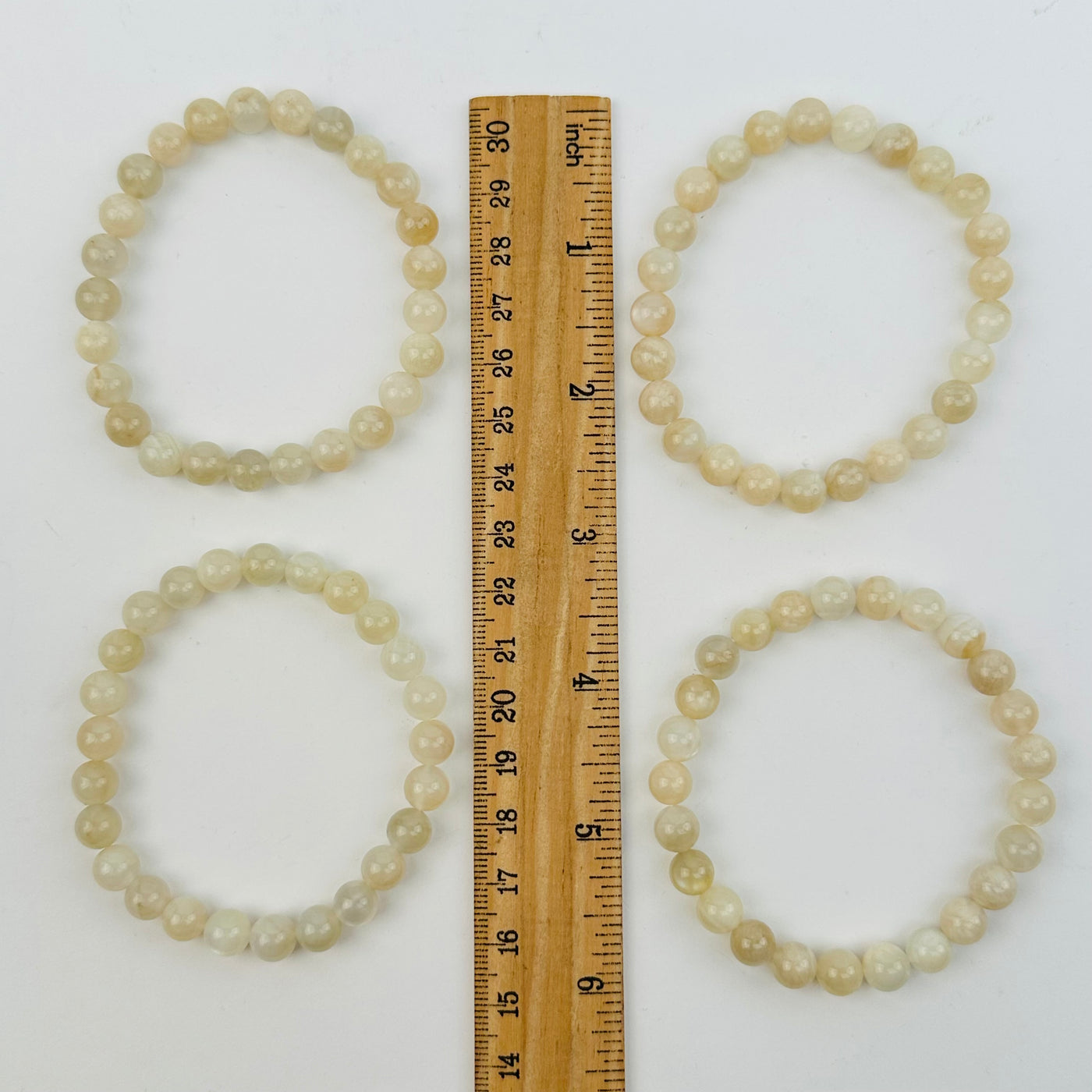 bracelets next to a ruler for size reference