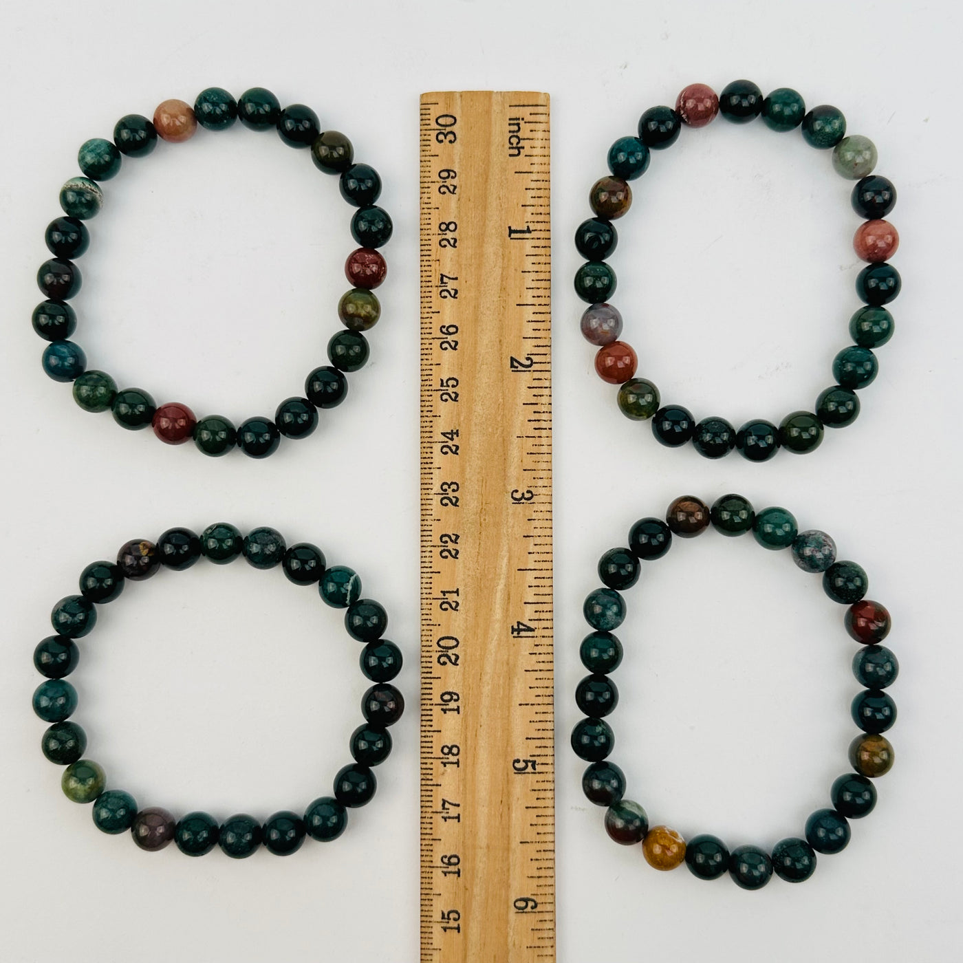 bracelets next to a ruler for size reference