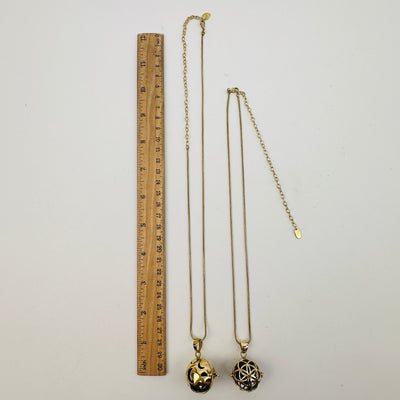 necklaces next to a ruler for size reference 