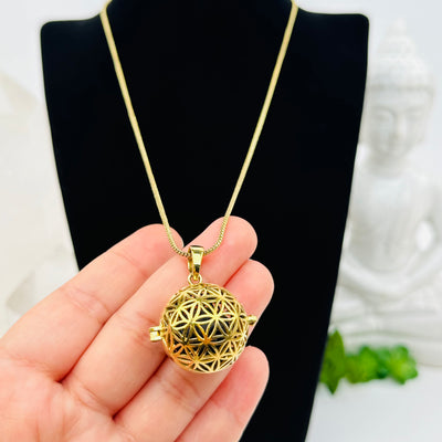 close up of the details on this flower of life necklace 