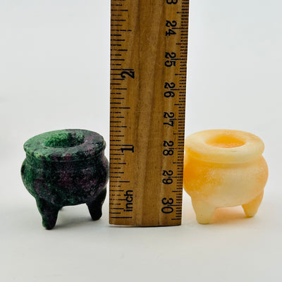 crystals next to a ruler for size reference 