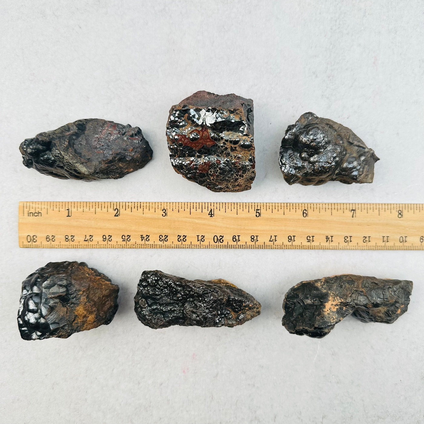 hematite clusters next to a ruler for size reference 
