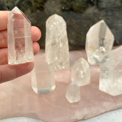 Lemurian Crystal Quartz Polished Point in hand for size reference 
