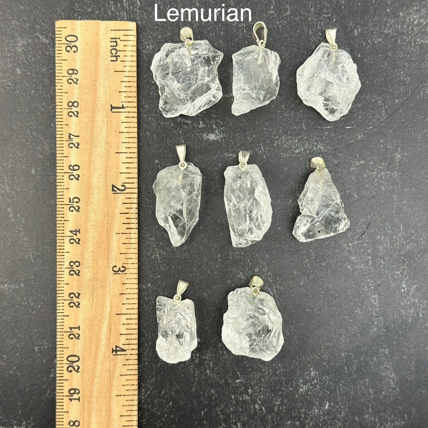lemurian pendants next to a ruler for size reference 
