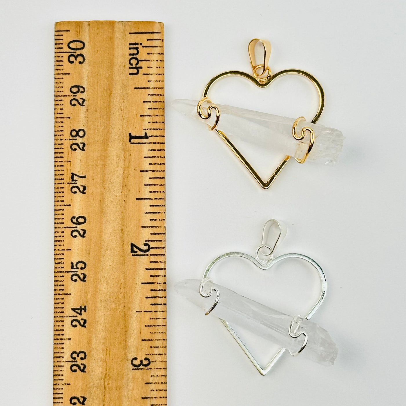 crystal pendants next to a ruler for size reference 