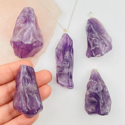 Amethyst Crystal Polished Jumbo Freeform Pendant in hand for size reference 