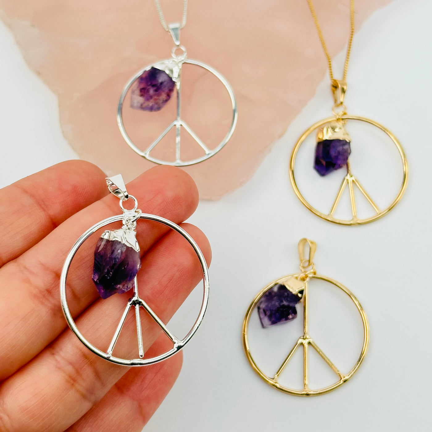 peace sign pendant in hand for size reference 