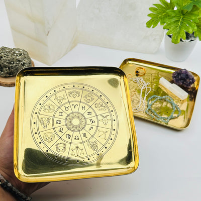 brass zodiac tray in hand for size reference 