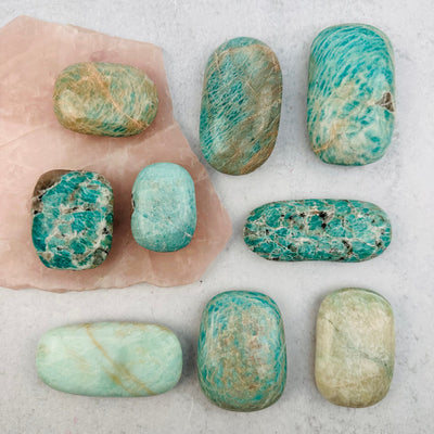 multiple palm stones displayed to show the differences in the sizes and color shades 