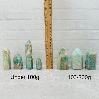 Amazonite Crystal Polished Tower Obelisk Point displayed next to a ruler for size reference 
