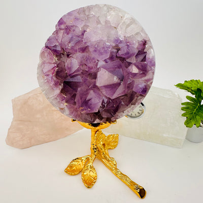 stem rose crystal holder with a large crystal sphere displayed as home decor 