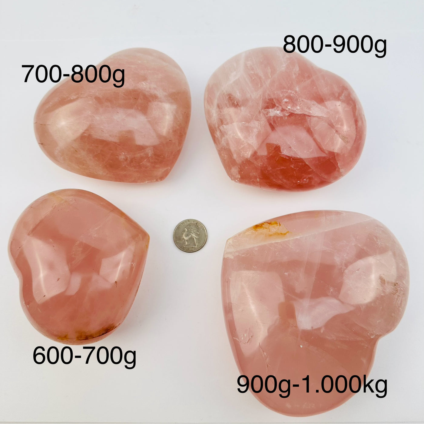 close up of rose quartz puff hearts next to a quarter for size reference and the weight in grams 