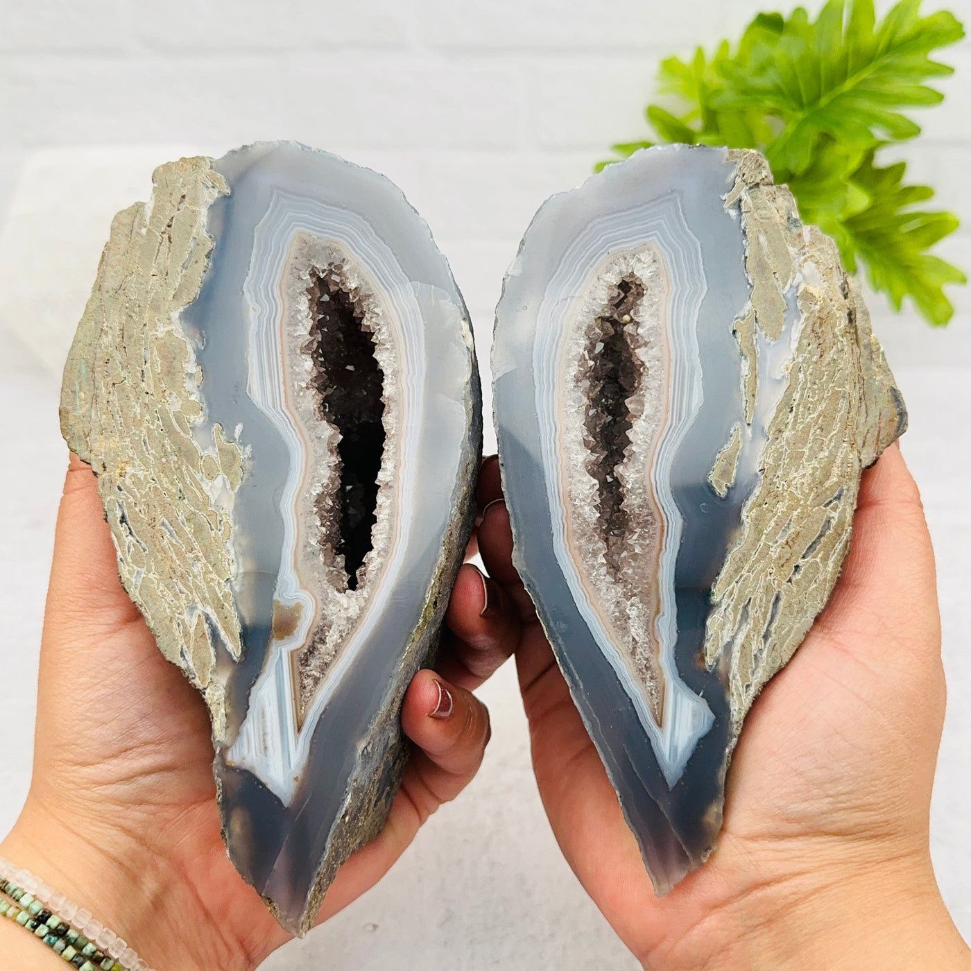 Agate Geode Crystal Pair in hand for size reference 