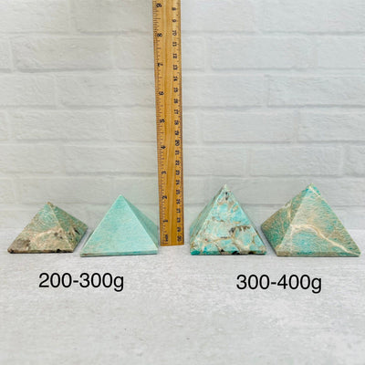 Amazonite Crystal Pyramids - By Weight - next to a ruler for size reference 