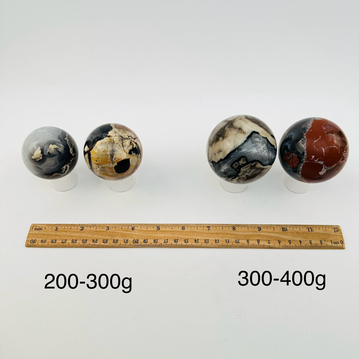 crystal spheres sold by weight. displayed next to a ruler for size reference 