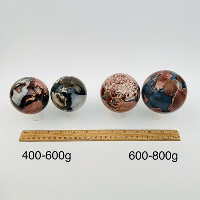 crystal spheres sold by weight. displayed next to a ruler for size reference 