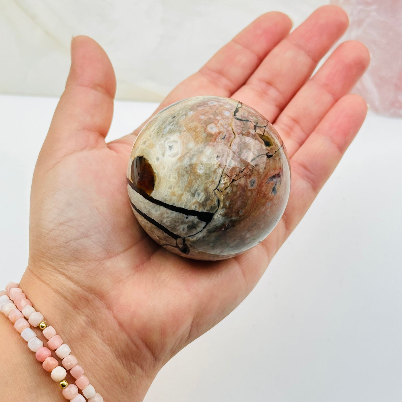 crystal sphere in hand for size reference 