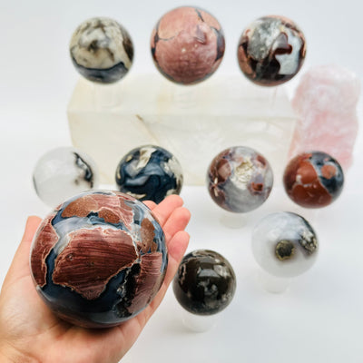 multiple volcanic agate spheres displayed to show the differences in the sizes and color shades 