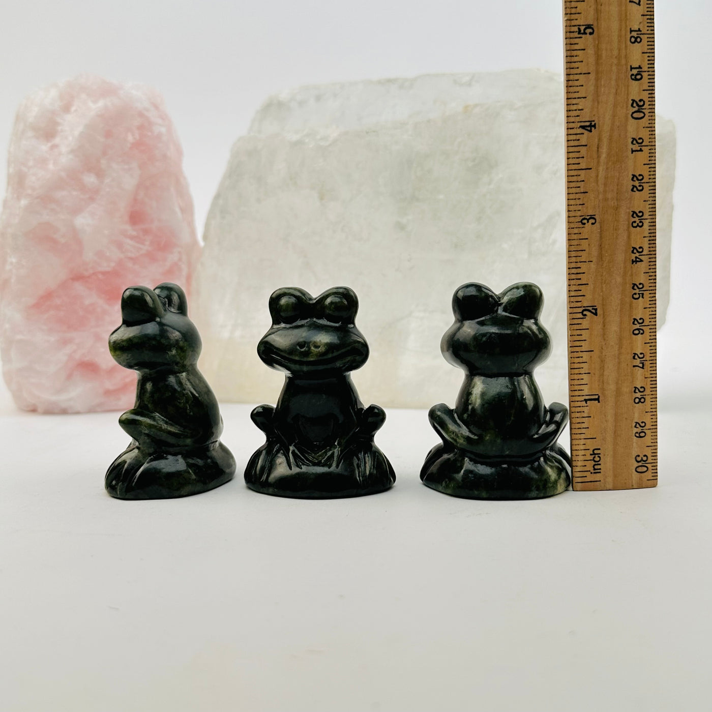 crystal frog next to a ruler for size reference 