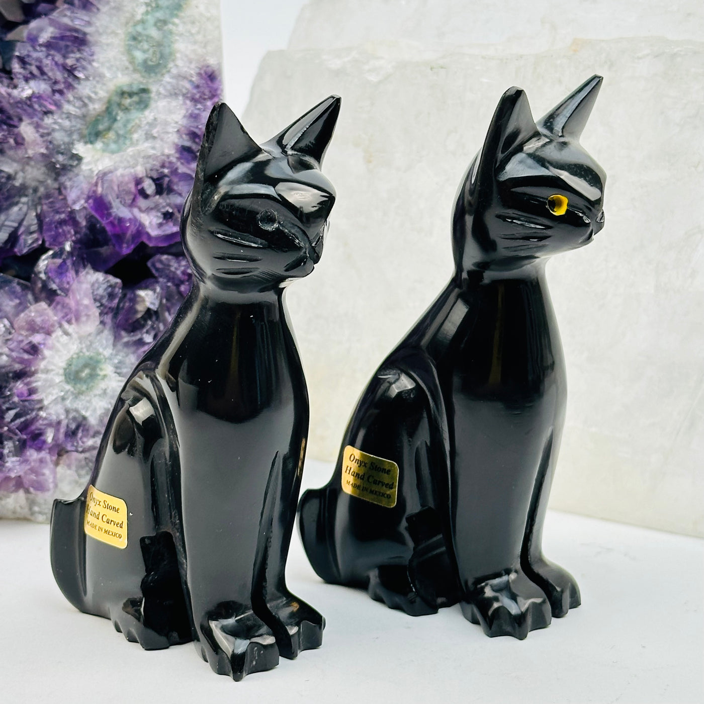 onyx cats turned to the side to show the details 