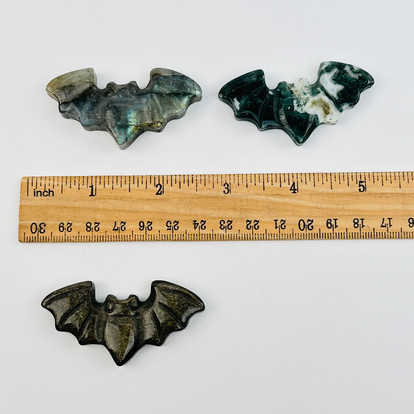 crystal bats next to a ruler for size reference 