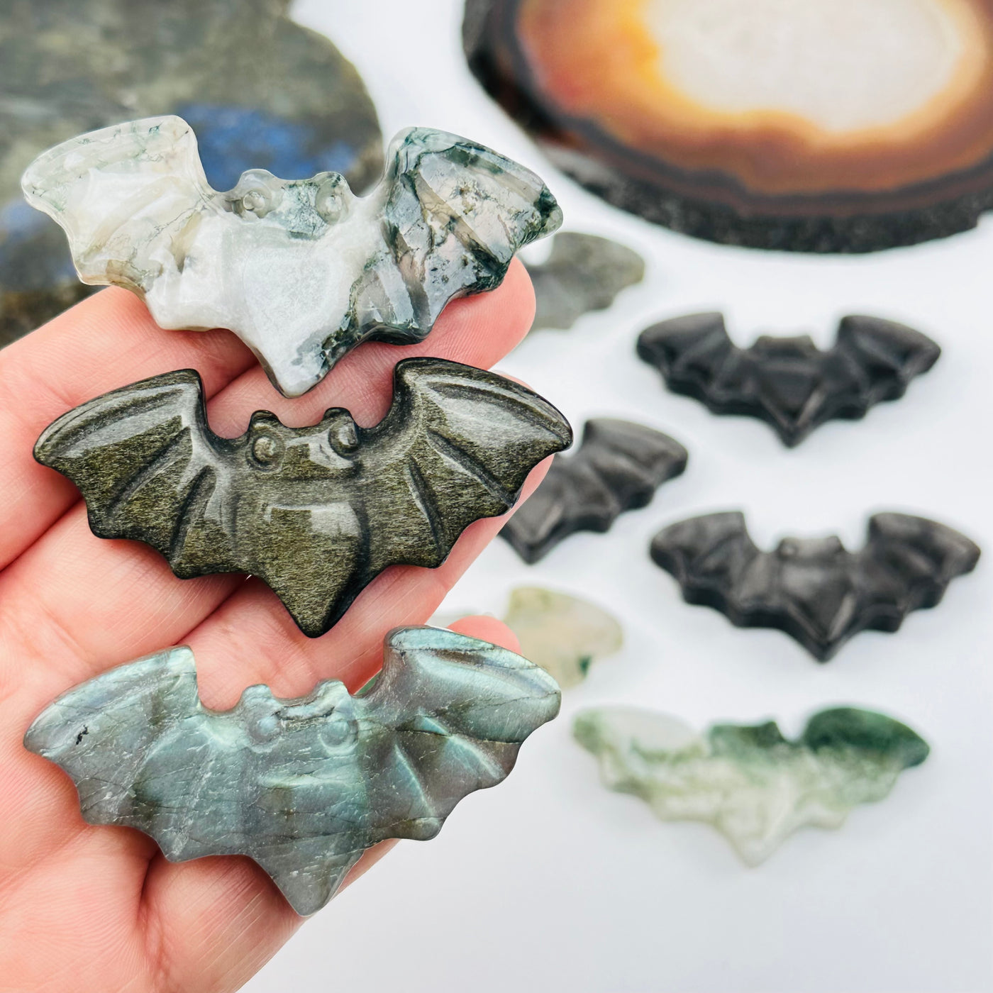 carved crystal bats on hand for size reference