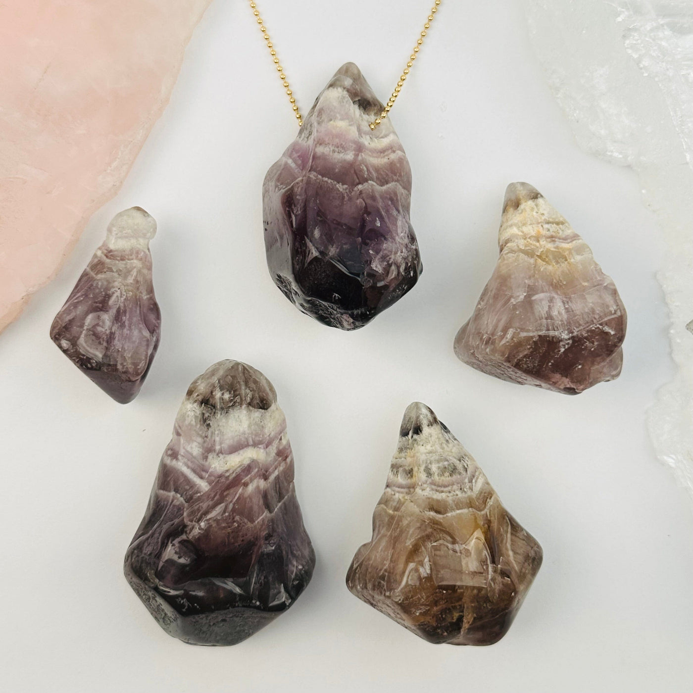 multiple pendants displayed to show the differences in the crystal sizes and color shades 