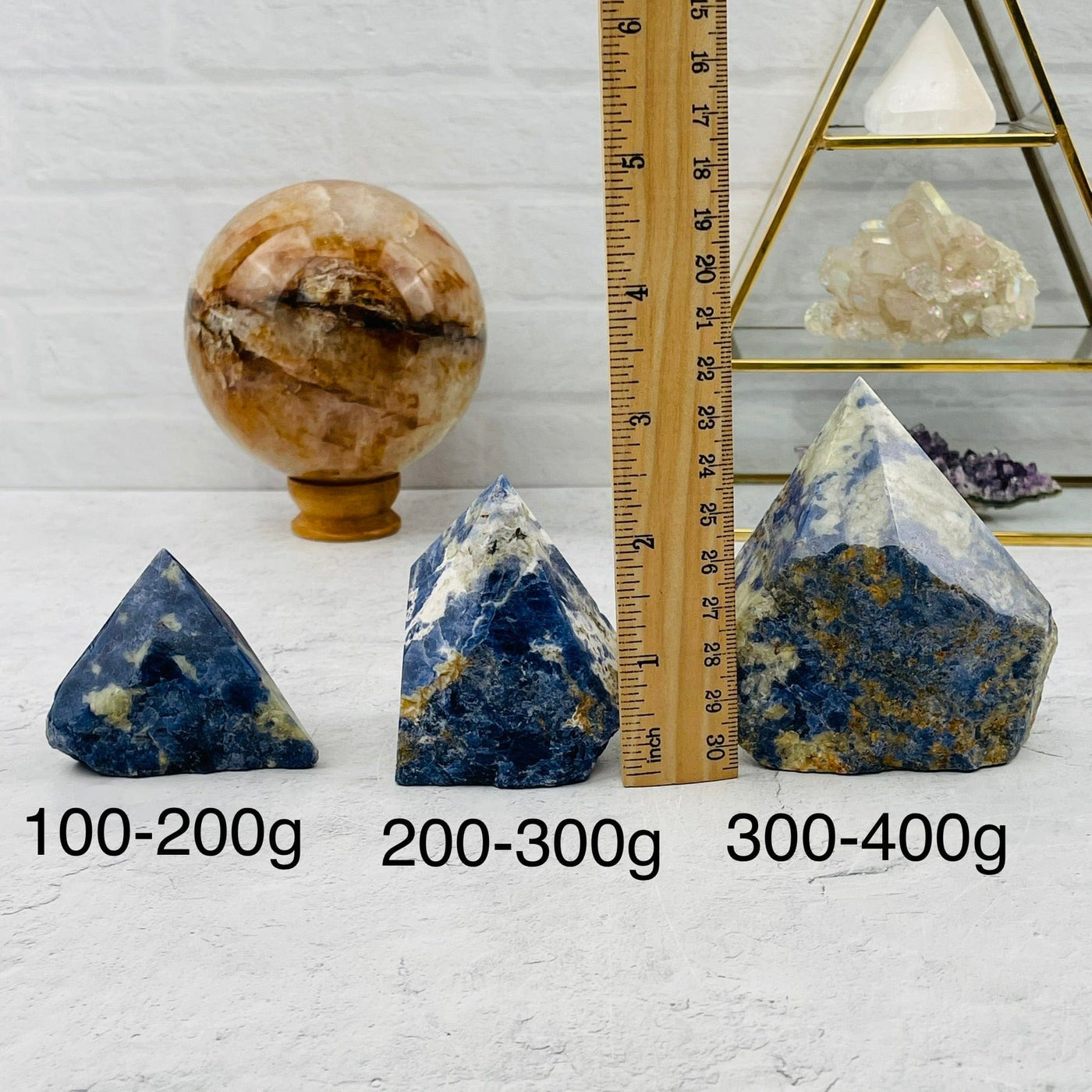Sodalite Semi-Polished Point High End - By Weight. displayed next to a ruler for size reference 