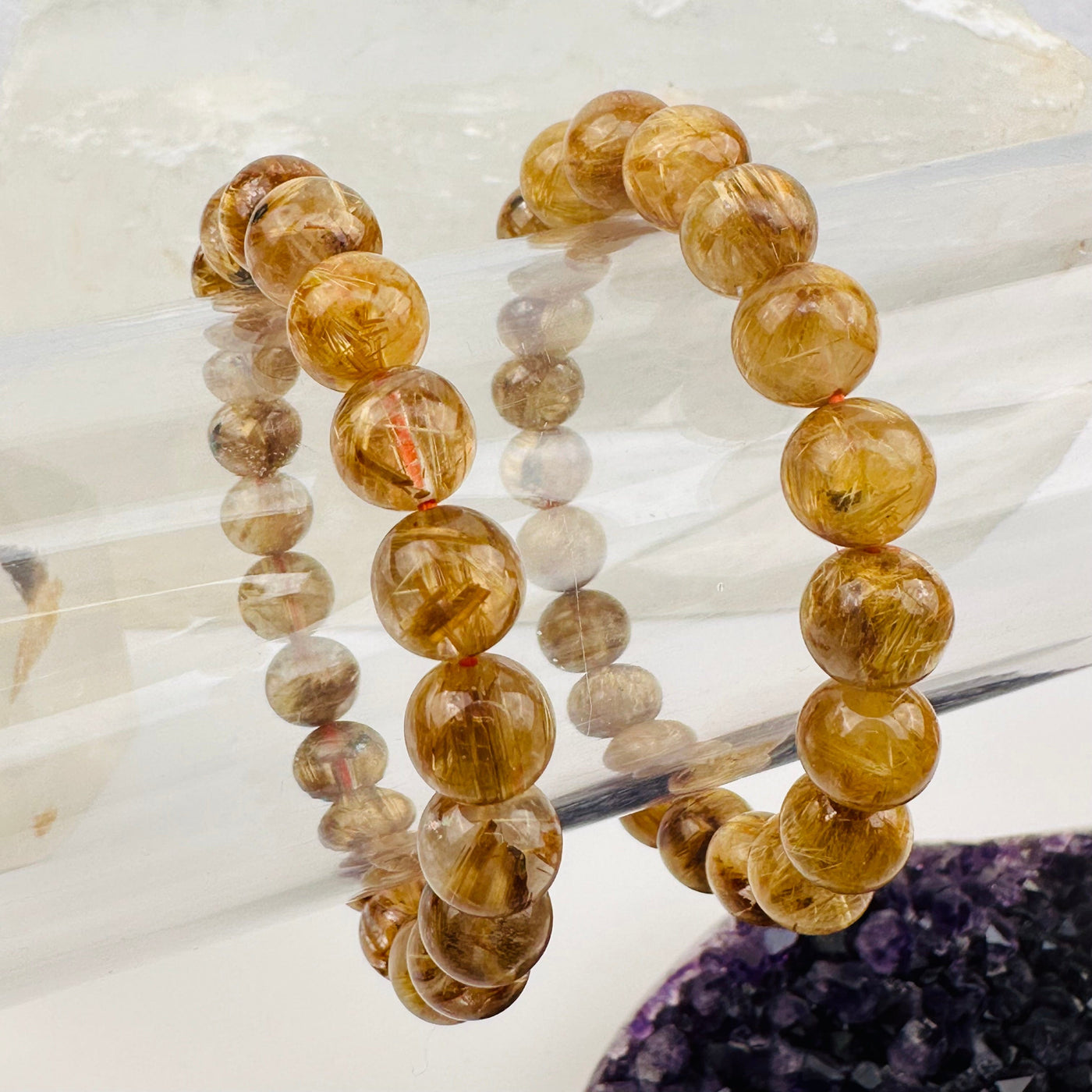close up of the gold rutile in these quartz beads 