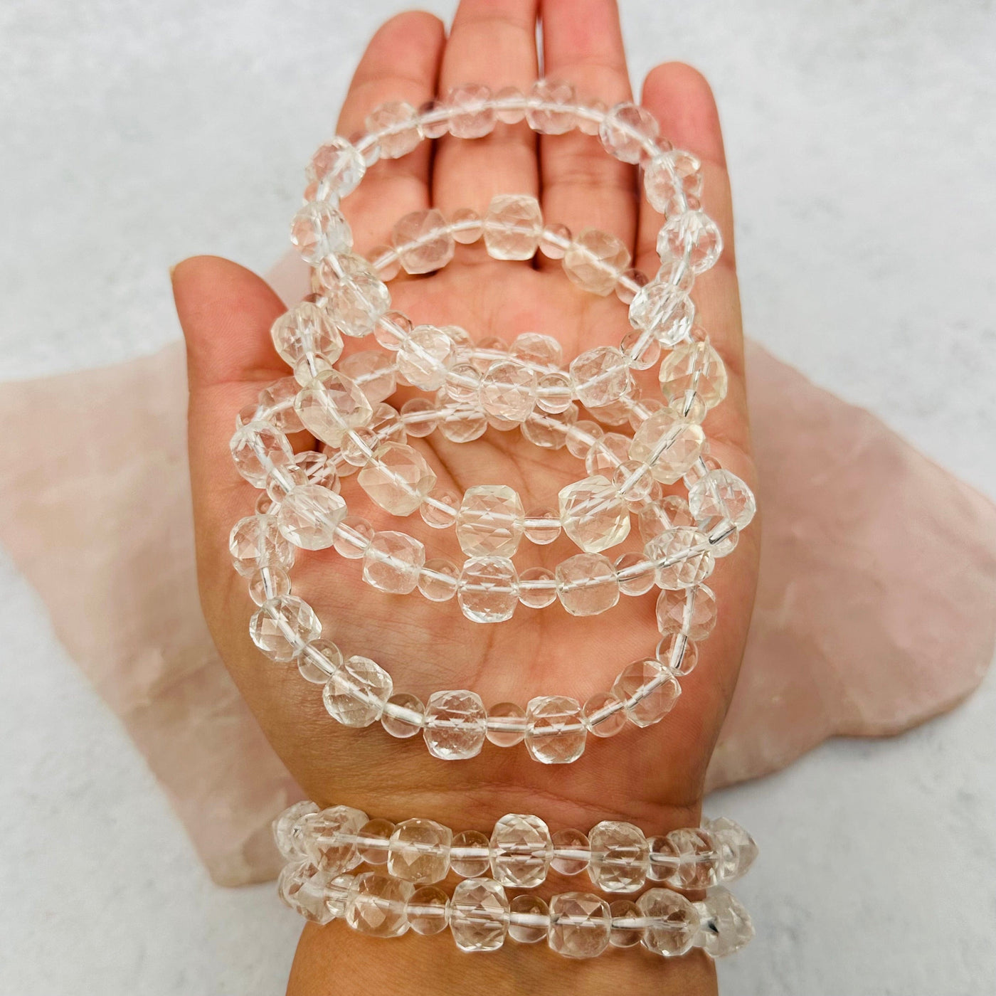 Crystal Quartz Faceted Bead Bracelets in hand for size reference 